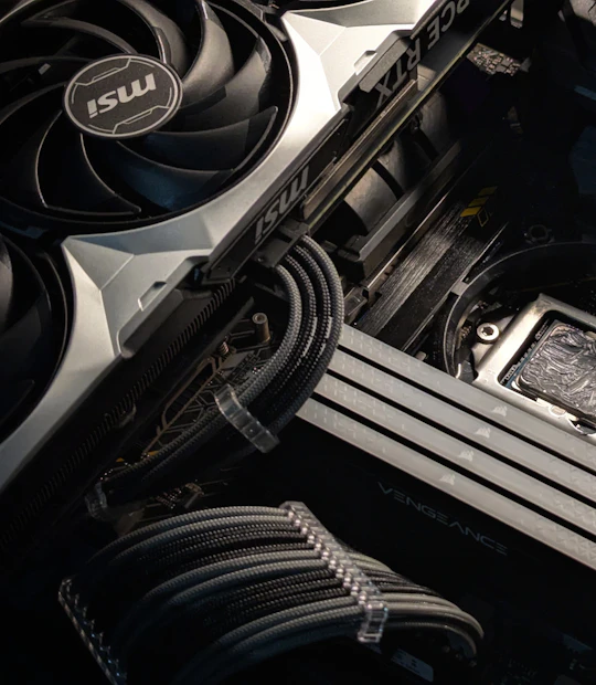 Sleeved cable management next to the graphics card and RAM inside a gaming PC